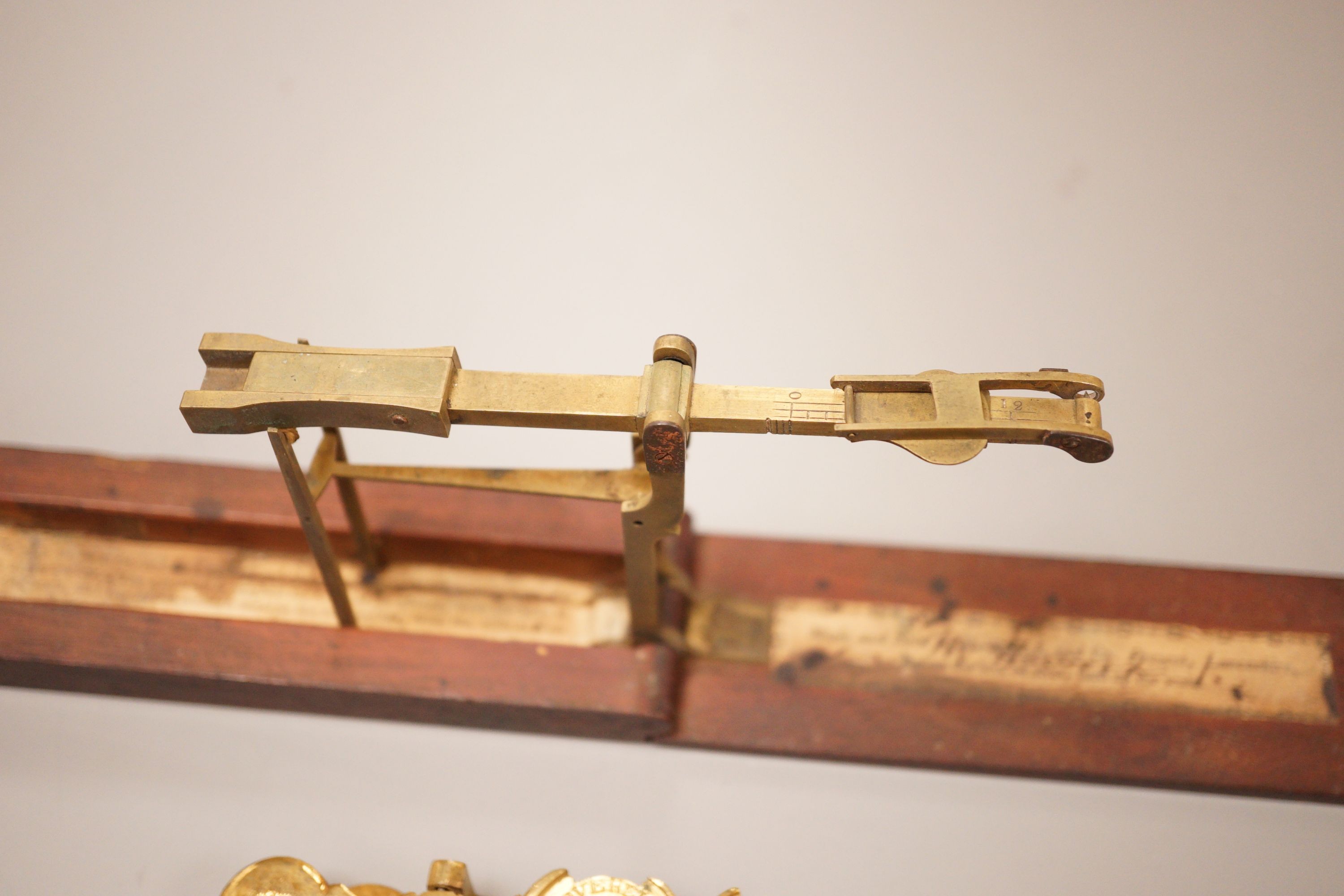 Two sets of gold / coin scales, together with a 1/2 pistol and 1 Guinea